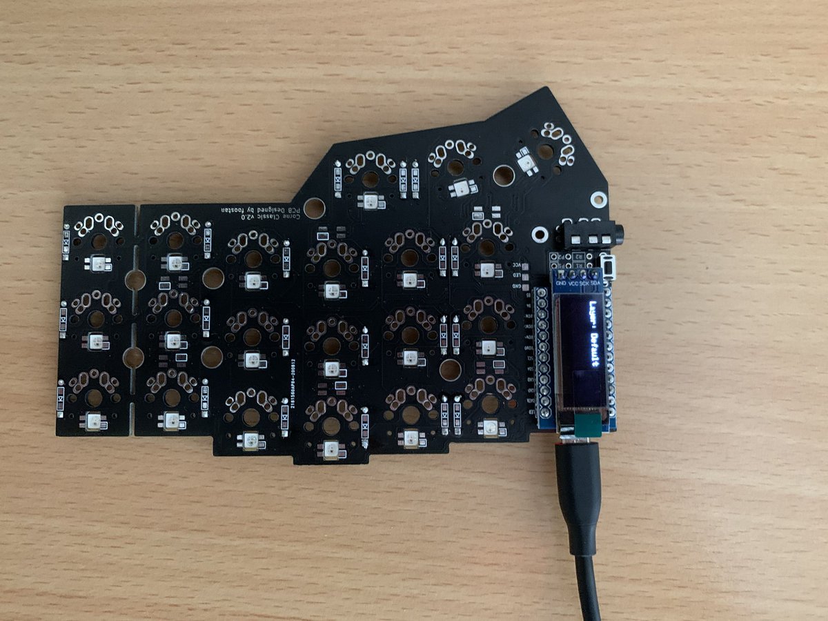 A fully populated keyboard PCB plugged in via a USB cable