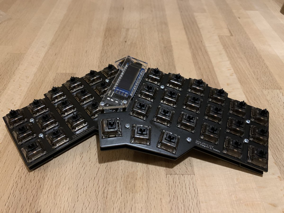 Two halves of a split keyboard, with switches but without keycaps
