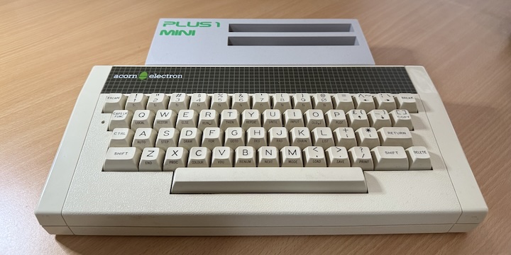 An Acorn Electron with a Plus 1 Mini expansion connected to the back.