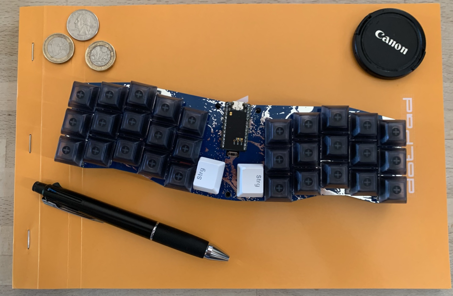 Manta keyboard with various objects for scale