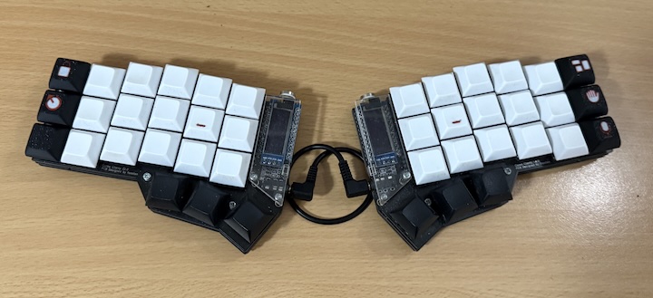 A split Corne keyboard with the above keycaps installed in the outermost columns